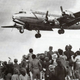 Residents of West Berlin watch as a US Air Force Douglas C-54 Skymaster lands at Tempelhof Airport. (US Air Force)